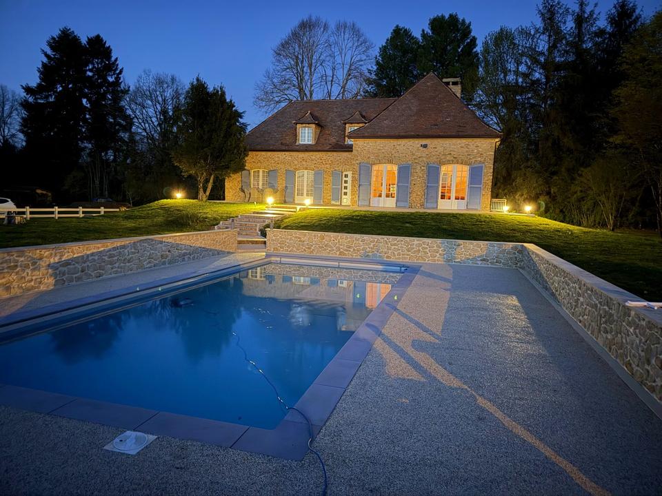 Beleuchtetes Haus und Pool in der blauen Stunde
