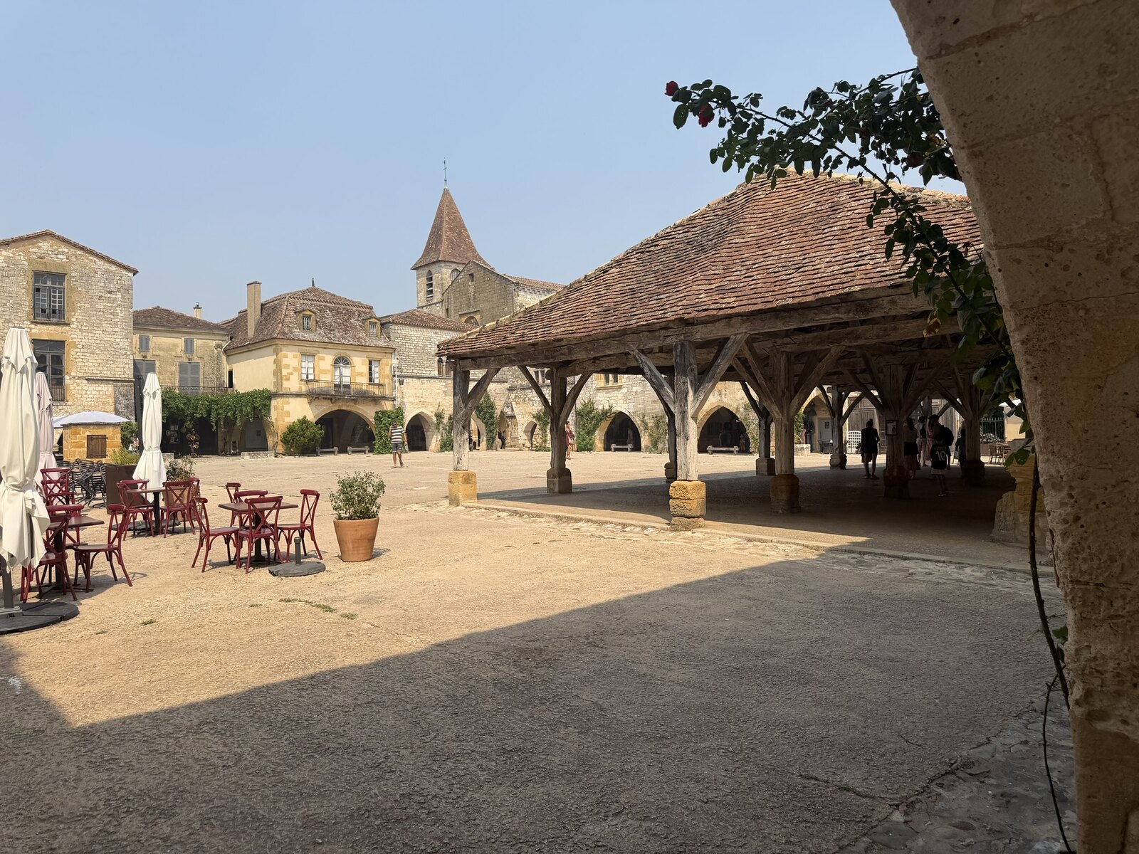 Place des Cornières in Monpazier with the timber market hall and stone arcades