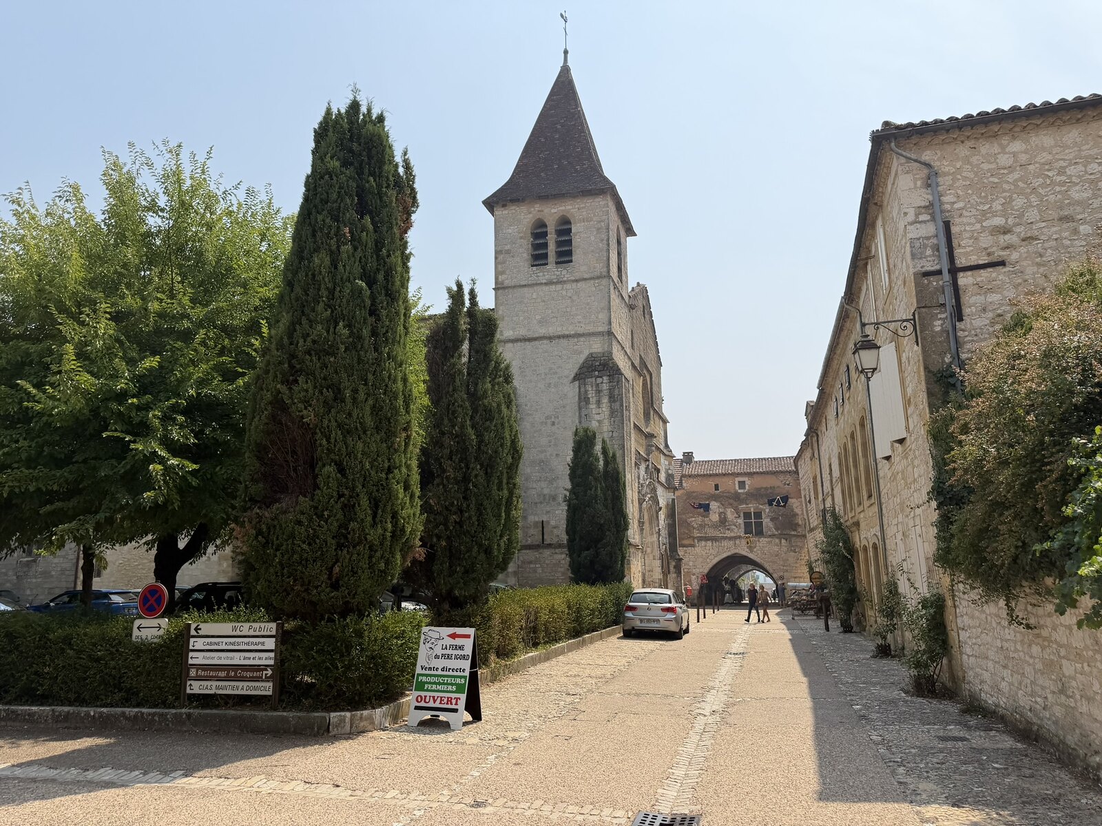 Saint-Dominique church in Monpazier viewed across the public space beside its stone façade